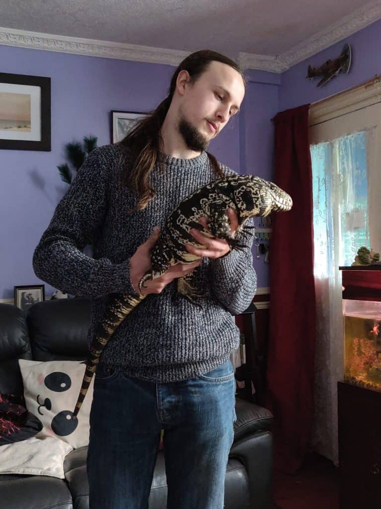 Calvin and his rescued Tegu lizard called Apollo. Hobbies of Wingham Wildlife Park, keepers.